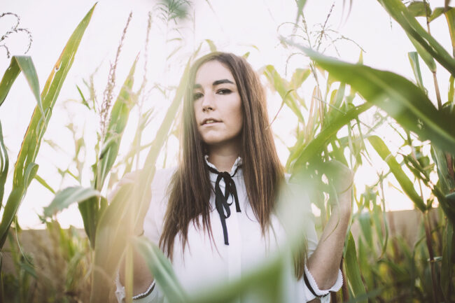 Portrait, Frau in Maisfeld, Nahaufnahme, Querformat