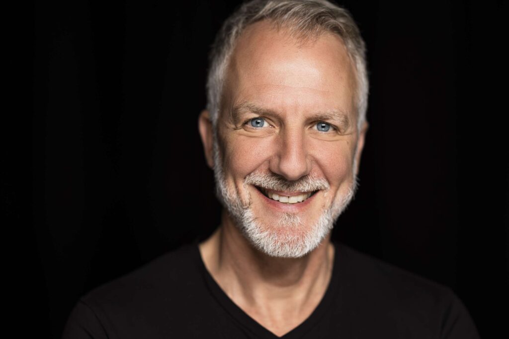 Ein laechelnder aelterer mann in einem professionellen studio portrait.